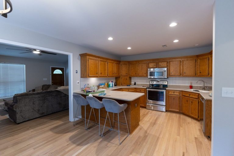 Aging in Place Remodeling: A Room-by-Room Plan for Lowcountry Homes Kitchen and living room of an occupied Ridgeville home with new site-finished red oak flooring running continuously between them